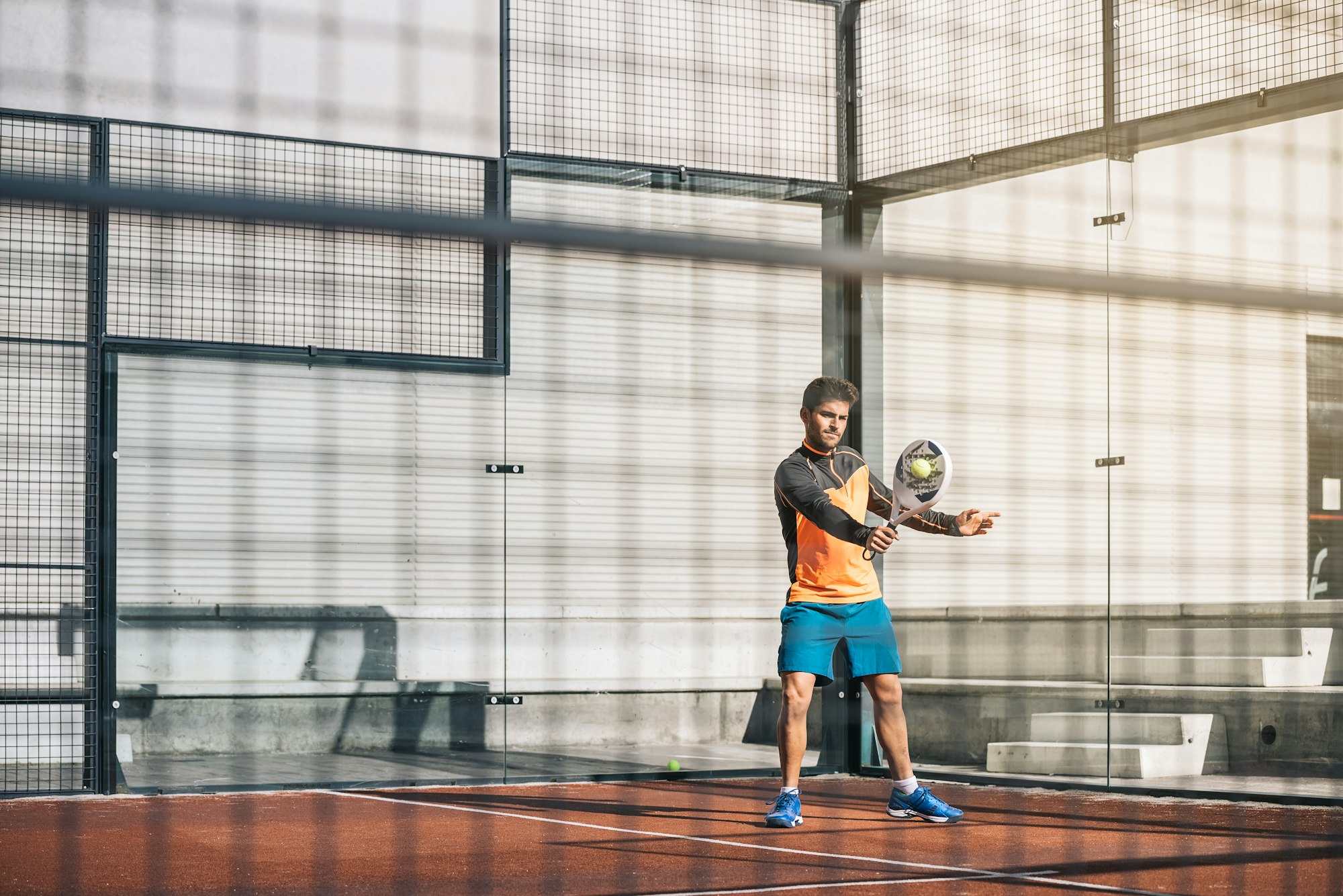 Player holding a Kuikma padel racket on court during a doubles match